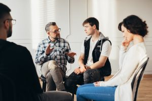 Therapist leads a group session during rehab
